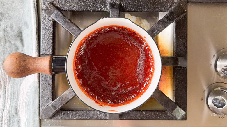 Gochujang sauce simmering in saucepan on stovetop