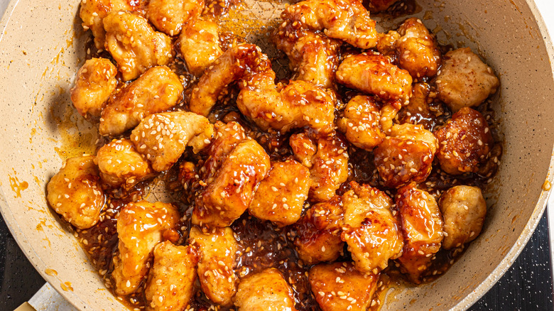 Cooked chicken pieces coated with sesame soy sauce