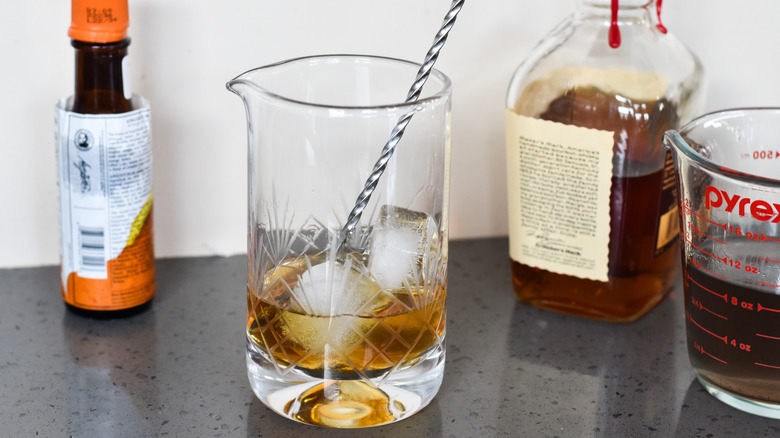 ice bitters whiskey mixing glass