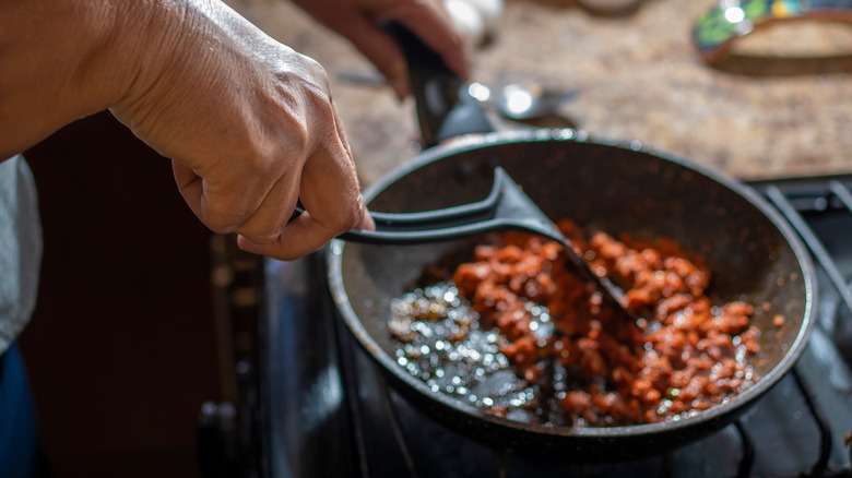 cooking sausage in skillet