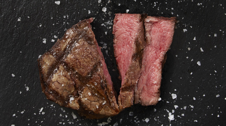 sliced steak and flaky salt on slate