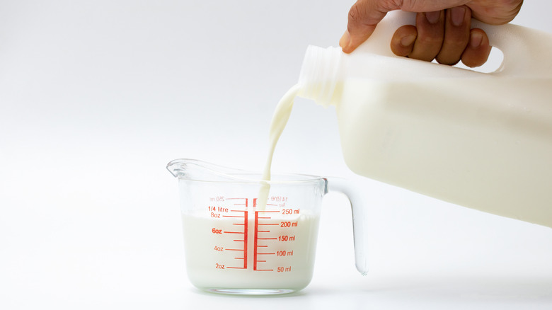 Pouring milk into measuring cup