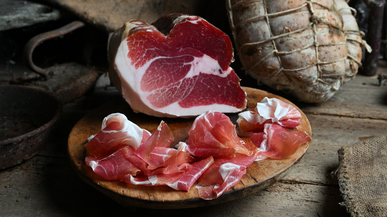 sliced Culatello arranged on wooden serving tray