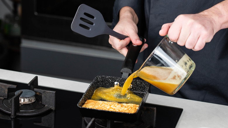 chef making tamagoyaki layers