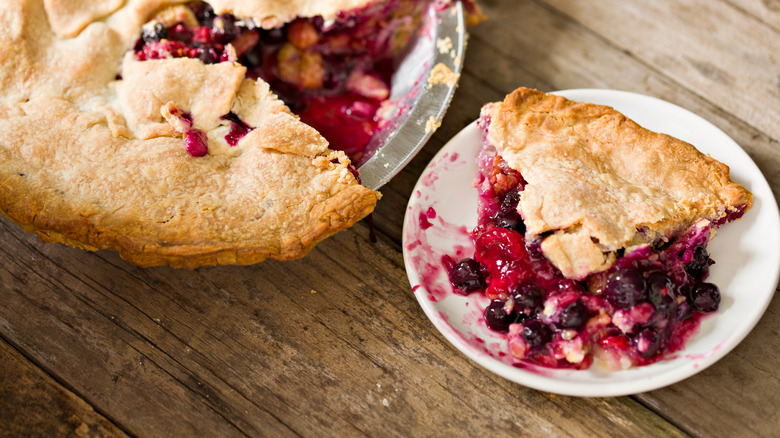 berry pie slices out of whole pie