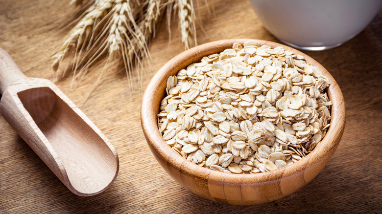 Wooden spoon and bowl of oats