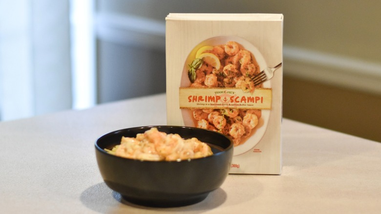 A black bowl of shrimp scampi on a white counter