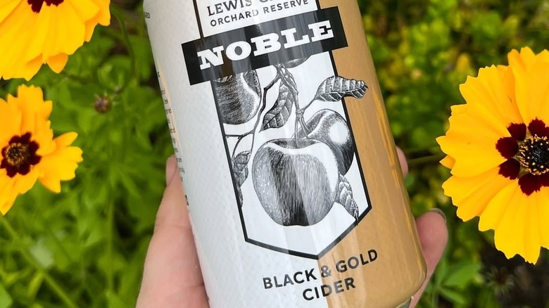 Close up on cider label in front of flowers