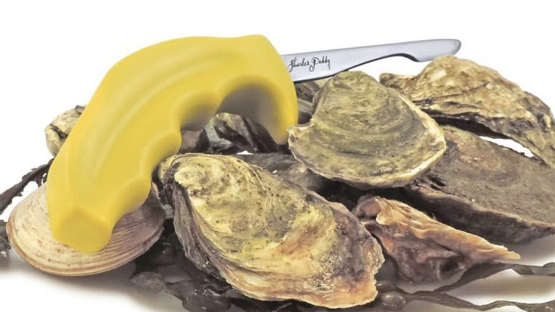 A yellow-handled Swissmar Shucker Paddy