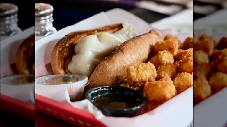 An Italian beef is served with provolone and tater tots.