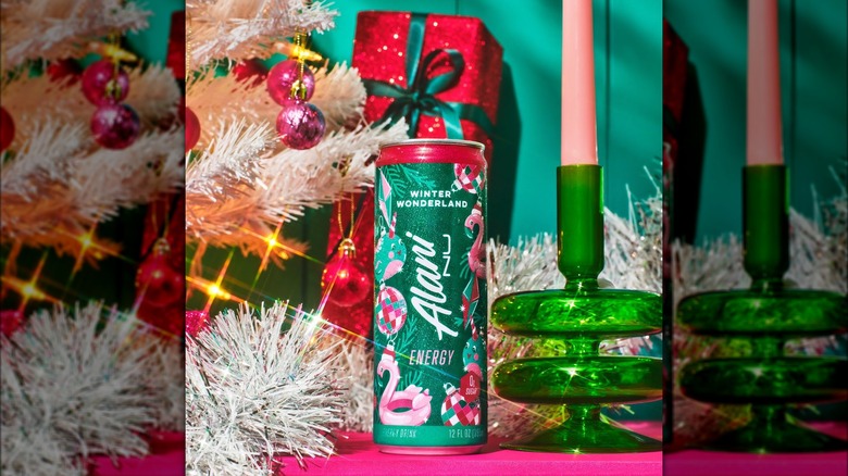 A can of Alani Winter Wonderland Energy Drink with Christmas decor surrounding it