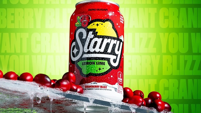 A can of Starry Lemon Lime soda on a green background with cranberries around it