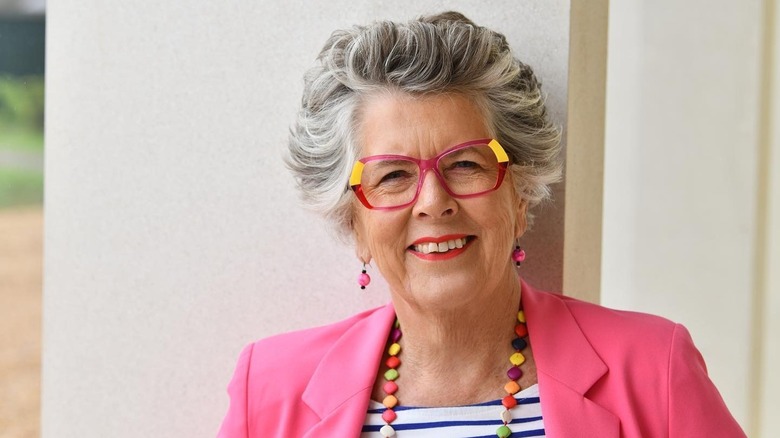 Prue Leith with pink blazer, colorful glasses and necklace