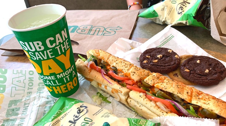 subway items including sandwich, cookies and drink cup