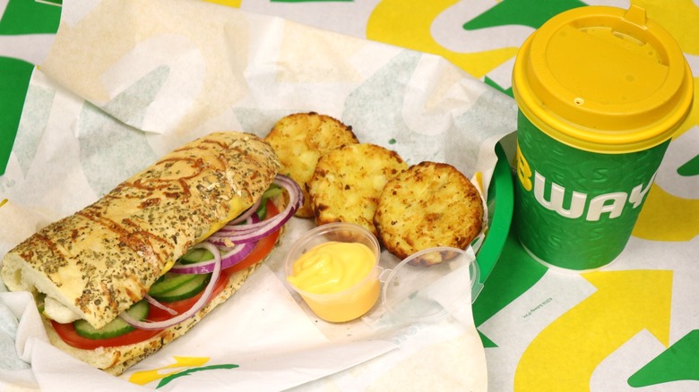 Subway sandwich, cup and hash browns