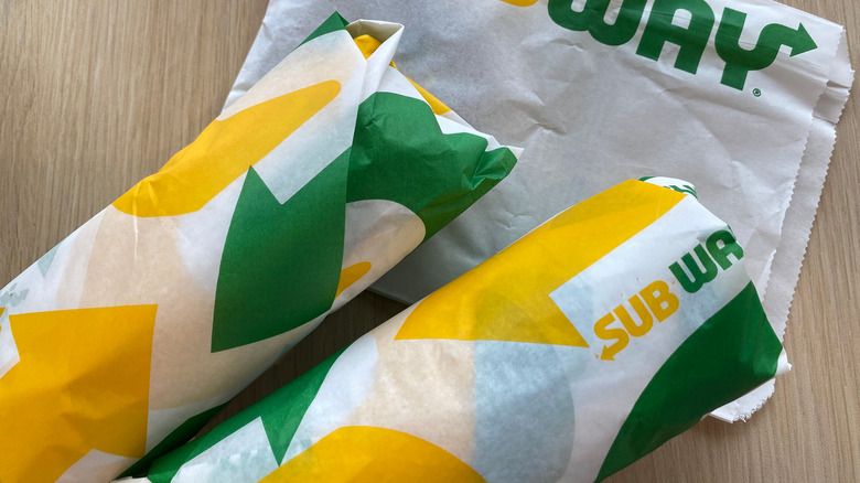 two wrapped Subway sandwiches