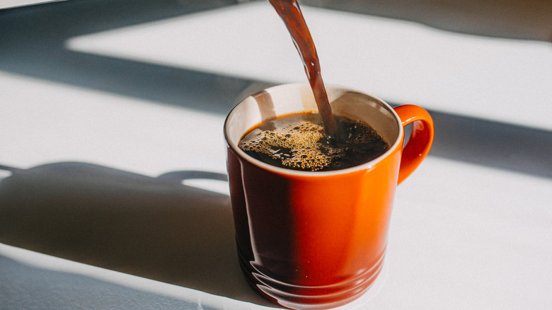 Coffee being poured into a cup