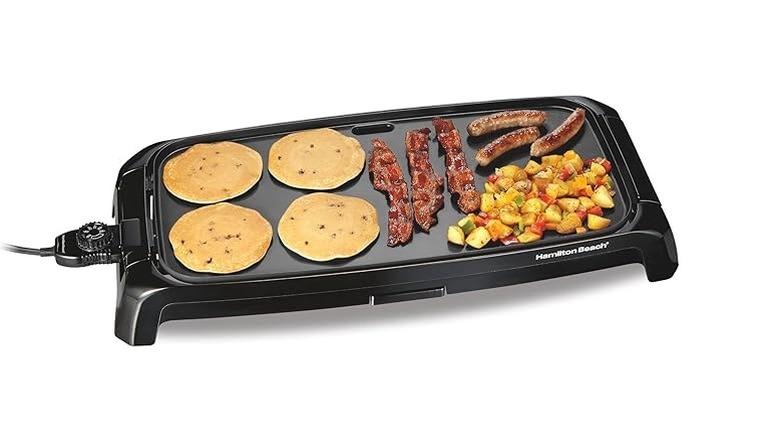 Hamilton Beach Durathon Reversible Ceramic Griddle with pancakes, bacon, sausages, and breakfast potatoes on top