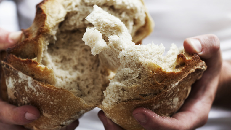 Hands breaking bread