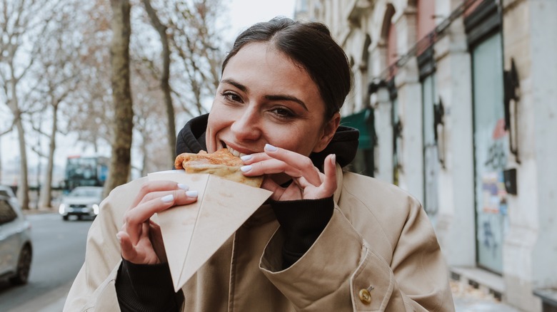 Woman eating a crepe