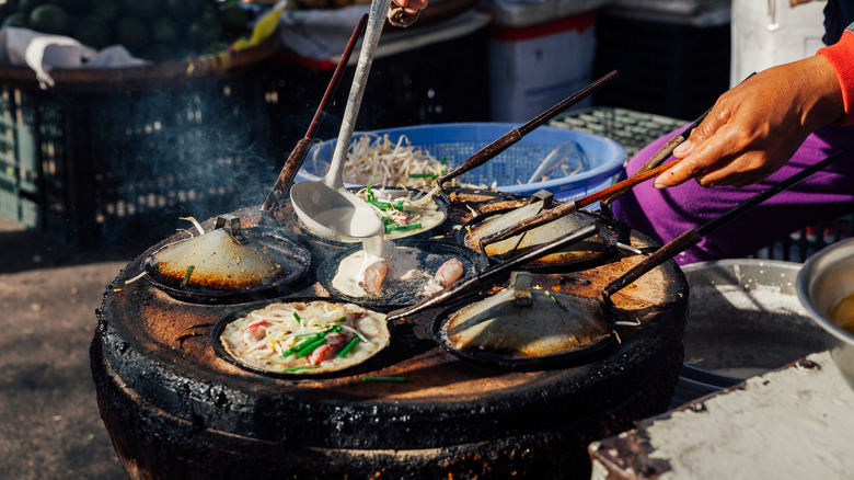 Woman serving seafood crepes