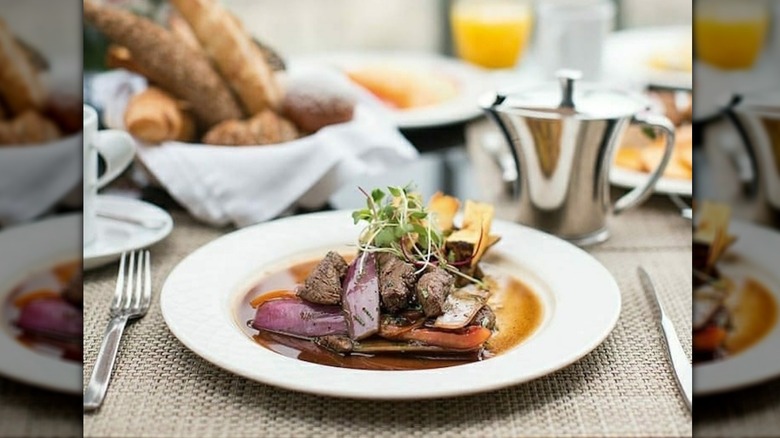 Steak dish with vegetables on Andean Explorer train