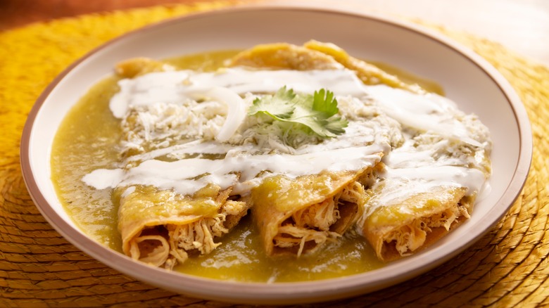 Green enchiladas topped with crema Mexicana