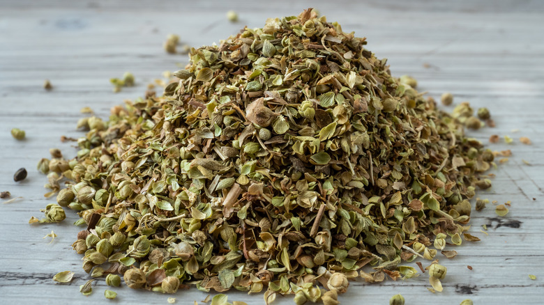 Pile of oregano on wooden surface