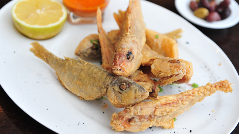 A plate of fried barbounia fish with lemon