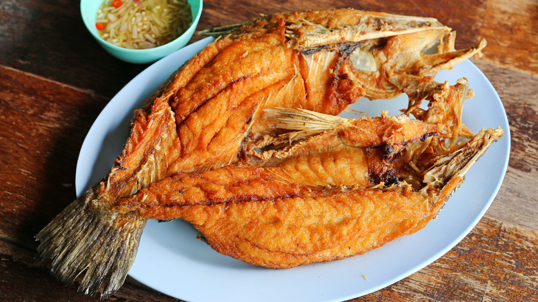 A deep-fried striped bass on a plate