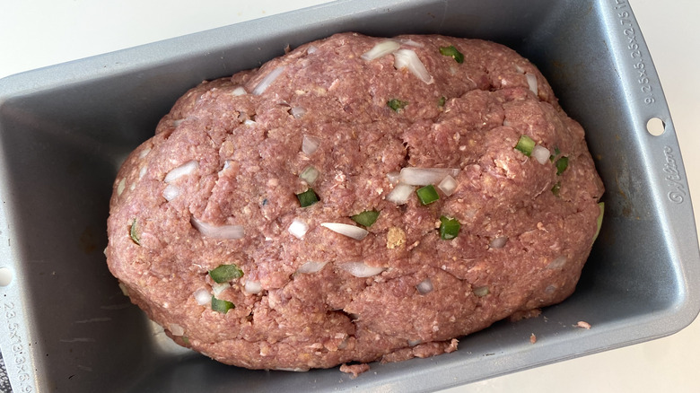 Uncooked meatloaf in pan