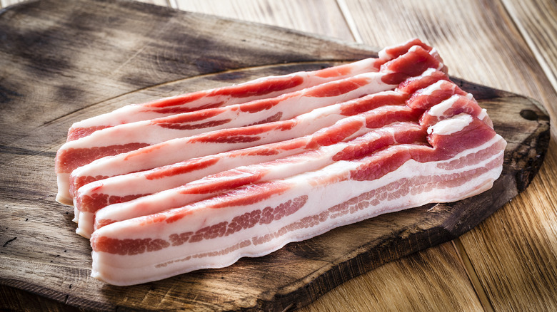 bacon slices on wooden board