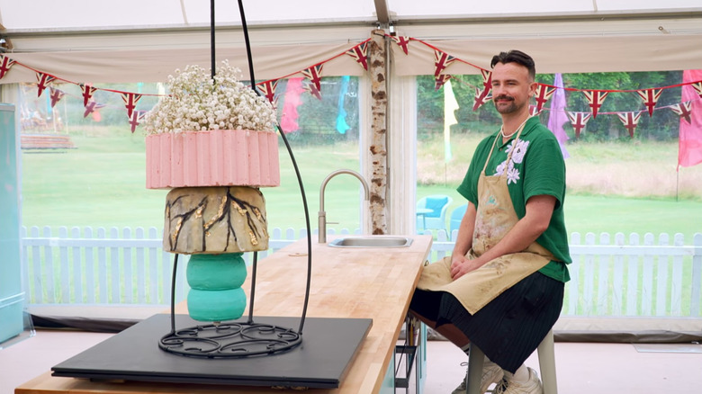 Christiaan De Vries smiling at his showstopper licorice cake