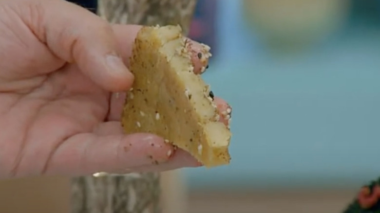 Paul Hollywood's handing holding Crystelle's raw focaccia