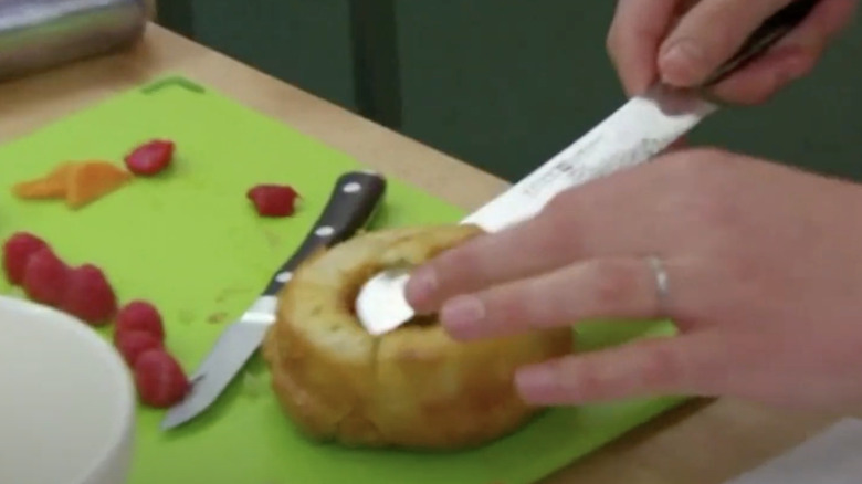 John slices salt off top of cake