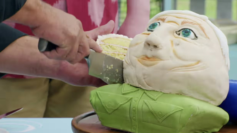 Paul cutting into Sura's David Attenborough cake