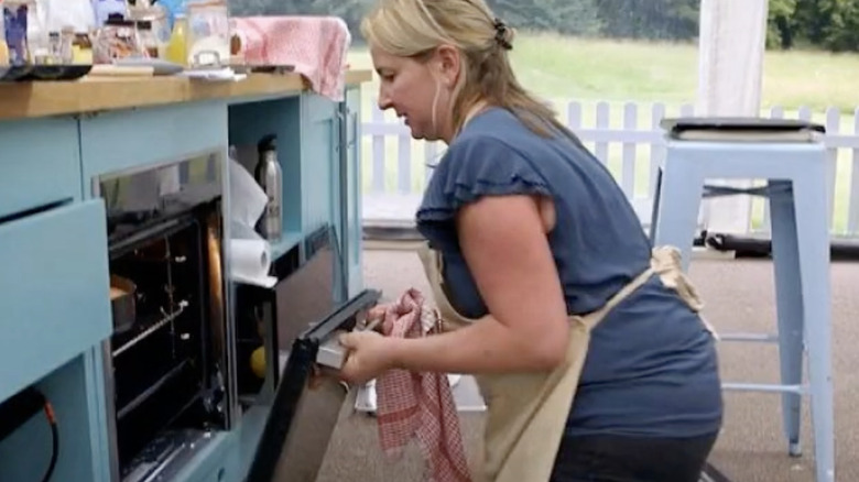 Stacey trying to put oven door back on