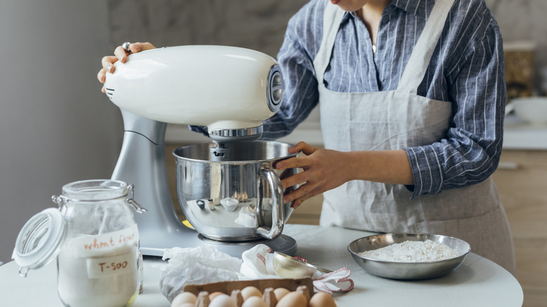 Person in apron using stand mixer