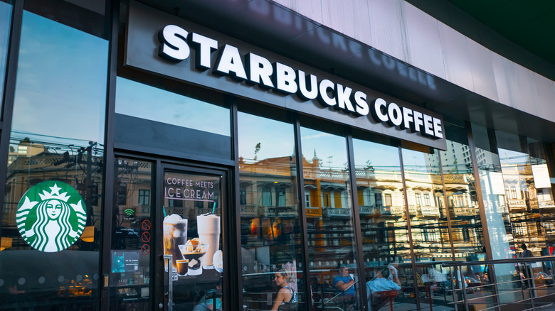 The storefront of a Starbucks Coffee with its iconic logo