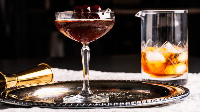 Manhattan cocktail with three cherries