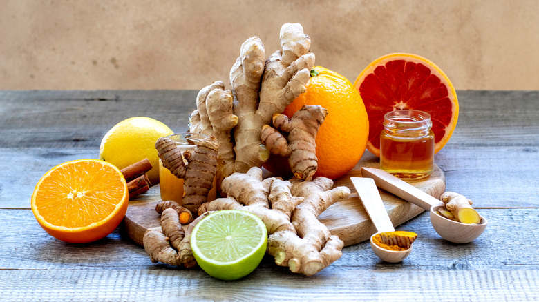 Ginger, citrus fruits, and honey on a wooden surface
