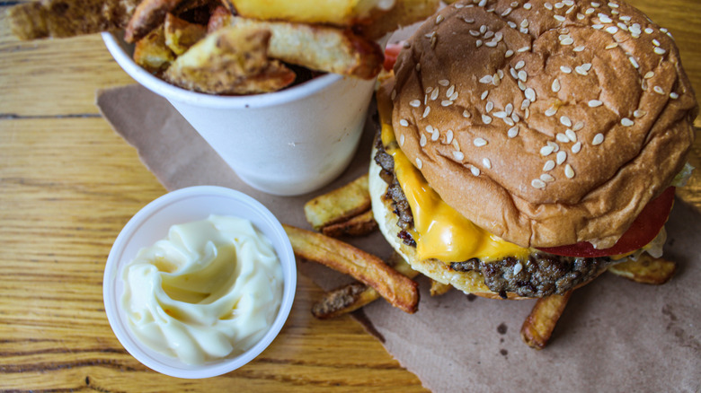 five guys burger with container of mayo and fries