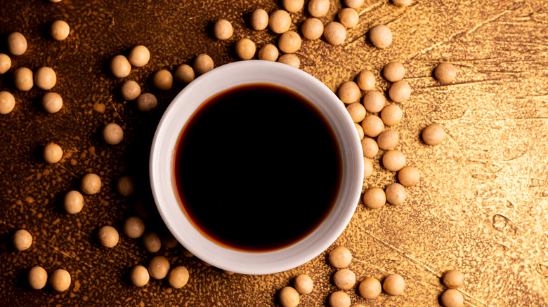 a bowl of soy sauce and soybeans