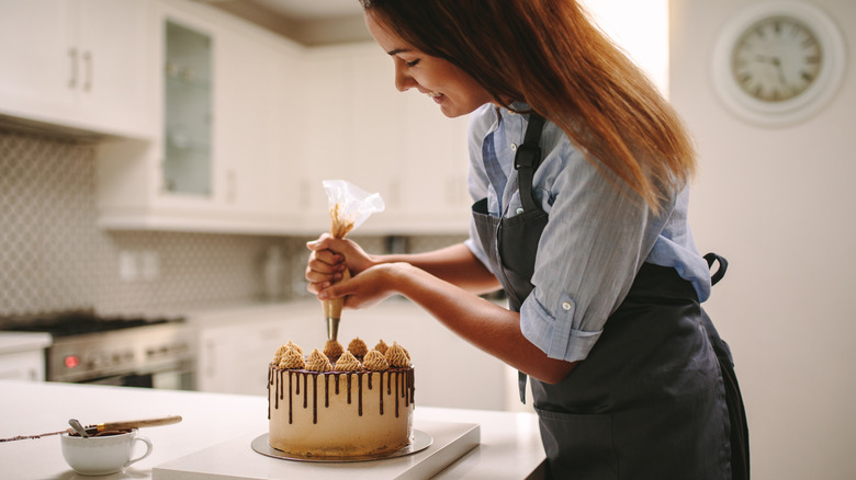 person decorating cake
