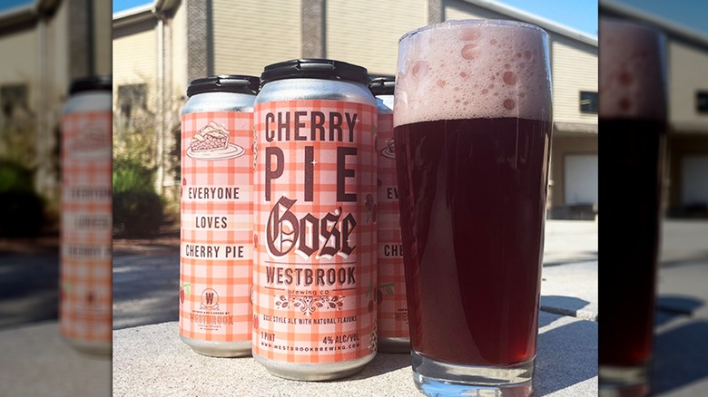 A can of Cherry Pie Gose next to a poured glass on an outdoor table