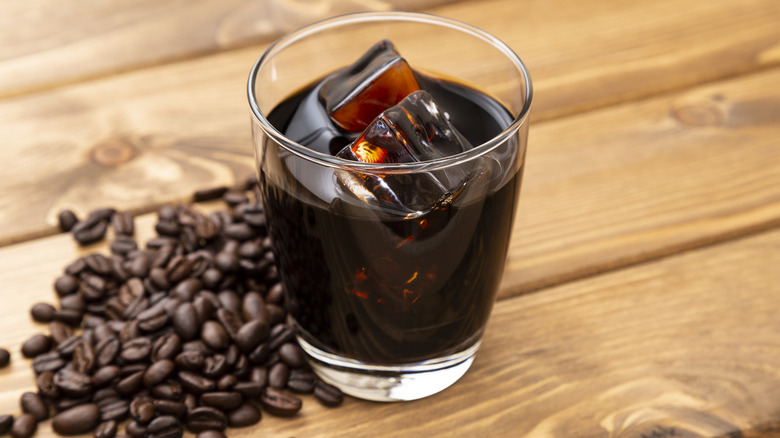 Cold brew in a glass with coffee beans