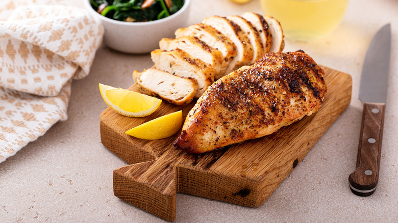 Grilled chicken on wooden board