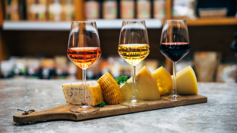 Three wine glasses on cheese board