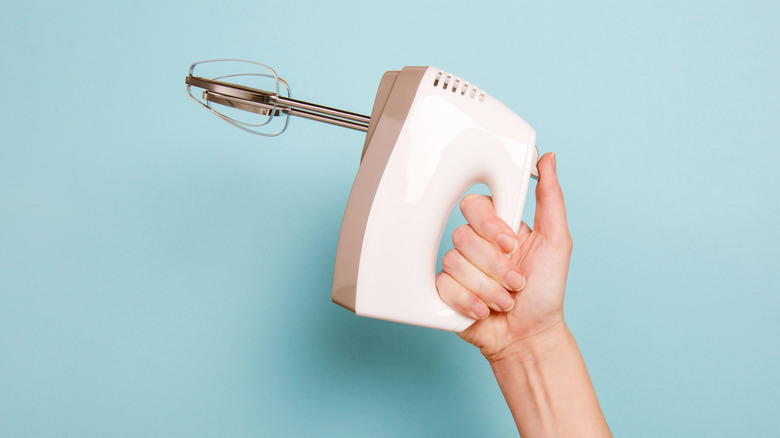 Electric mixer in woman's hand