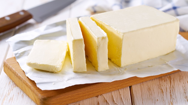 Sliced butter on wooden board